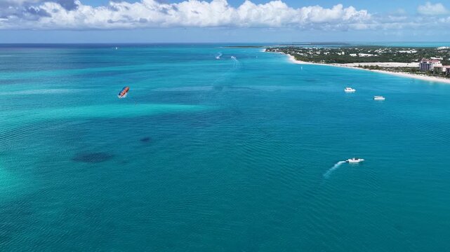 Parasail In Providenciales Overseas Territory Turks And Caicos Islands. Bird Eye View Of Stunning Parasailing Scene Over A Blue Ocean. Bay Water Landscape. Landmark Coast.