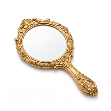 Vintage gold hand mirror with ornate floral carvings. Antique brass vanity mirror on white background. Elegant Victorian style handheld mirror.