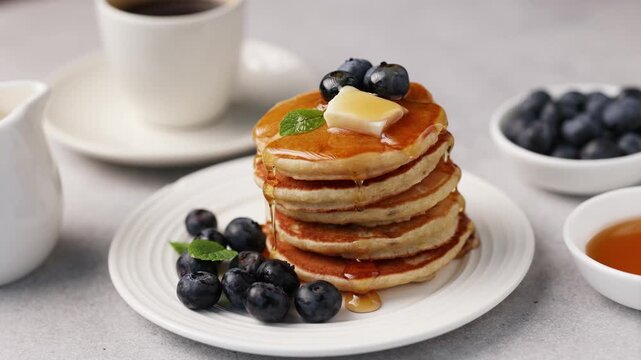 Pancakes with berries, butter and maple syrup