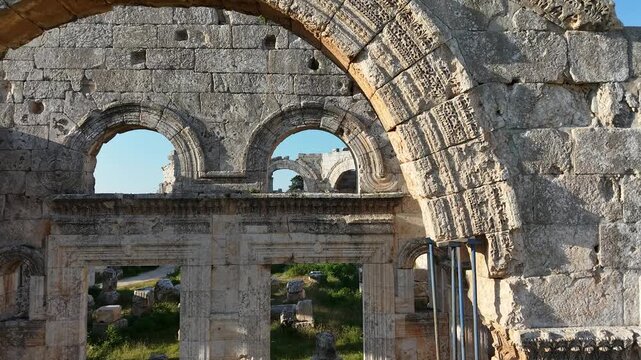 Aerial drone view of the historic ruins of Qal'at Semaan in Syria. Ancient stone architecture and arches at the Church of Saint Simeon Stylites. Famous archaeological site.