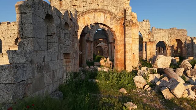 Aerial drone view of the historic ruins of Qal'at Semaan in Syria. Ancient stone architecture and arches at the Church of Saint Simeon Stylites. Famous archaeological site.