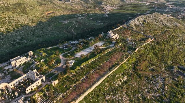 Aerial drone view of the historic ruins of Qal'at Semaan in Syria. Ancient stone architecture and arches at the Church of Saint Simeon Stylites. Famous archaeological site.