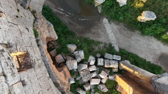 Aerial drone view of the historic ruins of Qal'at Semaan in Syria. Ancient stone architecture and arches at the Church of Saint Simeon Stylites. Famous archaeological site.