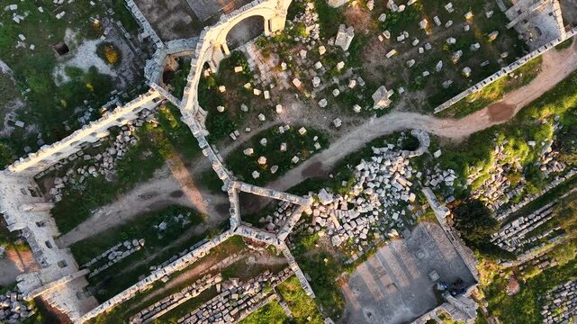 Aerial drone view of the historic ruins of Qal'at Semaan in Syria. Ancient stone architecture and arches at the Church of Saint Simeon Stylites. Famous archaeological site.