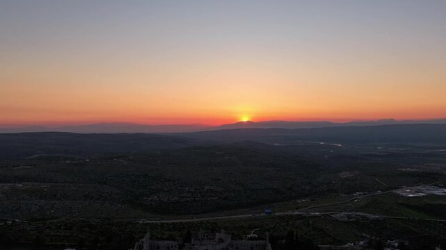 Scenic aerial drone shot of Qal'at Semaan historic site at sunset. Sunset background with an archaeological site. Ancient ruins and heritage in Syria. Tourism in post-war Syria.
