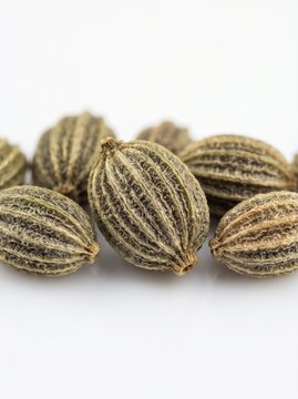 Ajwain seeds macro photography, dried carom seeds on white background, organic bishop weed spice for culinary and herbal medicine use