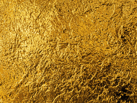 Intense golden abstract texture with a crinkled, metallic surface and a frosted glass effect, symbolizing wealth and prosperity.