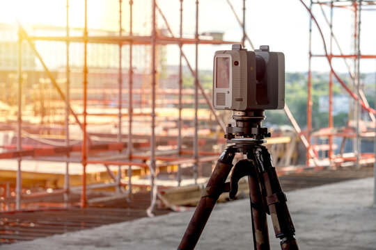 Sunlight glows behind construction scaffolding