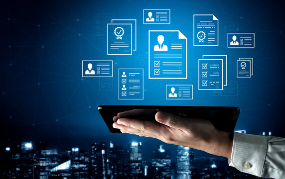 Digital Resume Management and Job Application Concept with Hand Holding Tablet and Virtual Career Documents in a Modern City Background. Entropy.