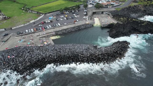 Aerial panoramic view of Pocos de Sao Vicente Ferreira, a volcanic natural swimming area on the north coast of Sao Miguel Island, Azores, Portugal.