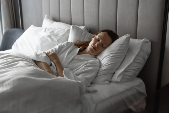 Peaceful Woman Sleeping Comfortably in Bed in the Morning
