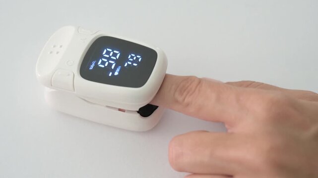 Close up of pulse oximeter measuring blood oxygen saturation and pulse rate