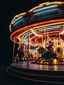 Carousel spin with colorful light streaks at night