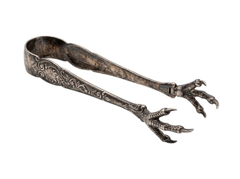 Antique silver sugar tongs claw foot shaped vintage silverware isolated on black background, ornate Victorian bird talon ice tongs for retro kitchenware, elegant tea service, and gothic table decor.
