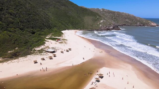 Drone Lateral View of Lagoinha do Leste Beach and Rocky Coast in Florianopolis Brazil, Lifeguard Stand and Remote Sand Shoreline with Ocean Waves, Pristine South America Wilderness Travel Footage
