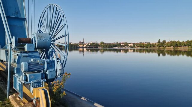 Harbor winch and cable wheel overlooking Ziegelinnensee in Schwerin, Germany