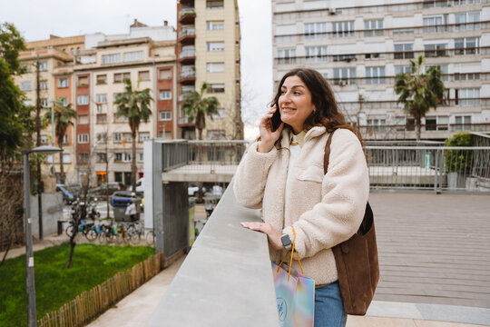 Woman talking phone during a birthday celebration