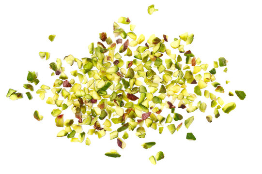 Pistachios chopped scattered, pile isolated on white background and texture, top view, clipping path