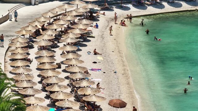 Podstrana Beach With Umbrellas And Swimmers, Croatia
