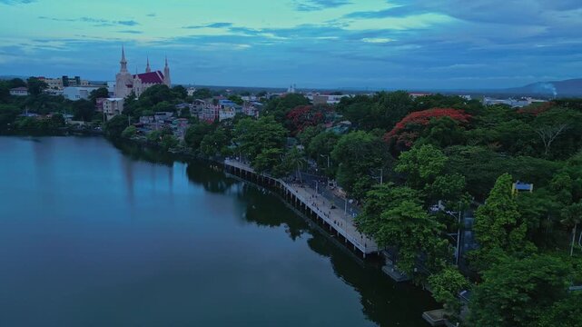 Cinematic forward drone flight approaching Iglesia Ni Cristo [San Pablo City, Laguna District Office] with Mount San Cristobal standing prominently in the distance together with residential areas.
