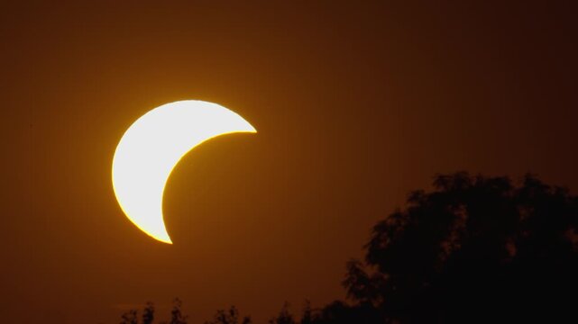 Solar eclipse observed with phases captured in four frames in a clear sky