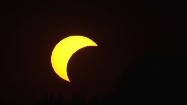 Solar eclipse viewed from multiple angles with changing light conditions