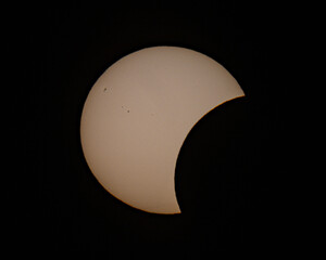 Partial solar eclipse phase with crescent sun against dark background © Veljko Klarić