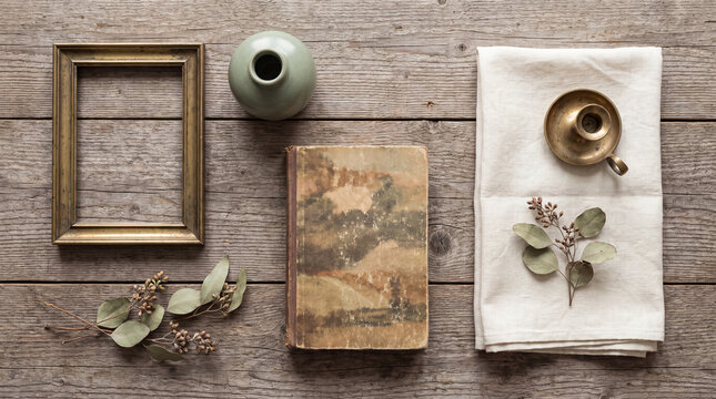 Vintage thrift finds flat lay with frame book vase and linen