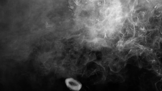 Smoke or fog moving on the ground, approaching fog on a green chrome key background, fog creeping along the floor and approaching the viewer, seamless loop of smoke. White smoke horizontal motion