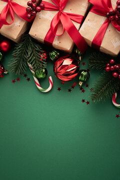 Festive Christmas presents wrapped in craft paper with red ribbons and holiday ornaments composition