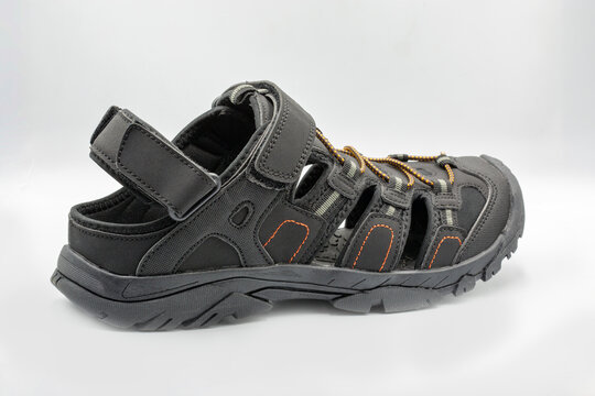 Mens black sporty trekking sandals active footwear closeup on white.