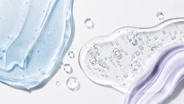 Luxury skincare cosmetic textures in translucent icy-blue and pale-lavender gels with glossy surfaces and delicate air bubbles on a clean white background.