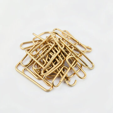 Pile of shiny brass paper clips on white background