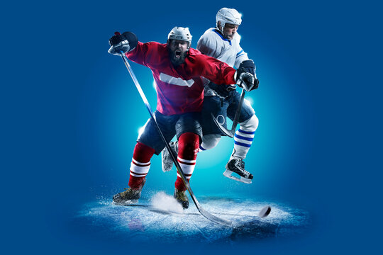 Hockey. Professional hockey player isolated on blue background. Hockey player in action. Hockey concept. Sport