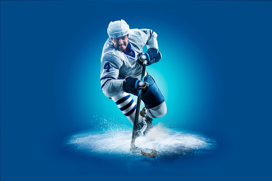 Hockey. Professional hockey player isolated on blue background. Hockey player in action. Hockey concept. Sport