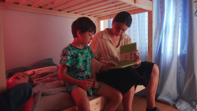Mother and son sharing one on one reading session on bunk bed creating supportive learning environment focused on literacy development curiosity and parental involvement