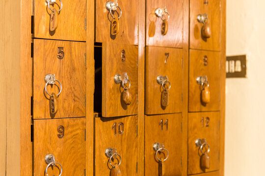 Wooden cells with keys for storing cell phones in Italian restau