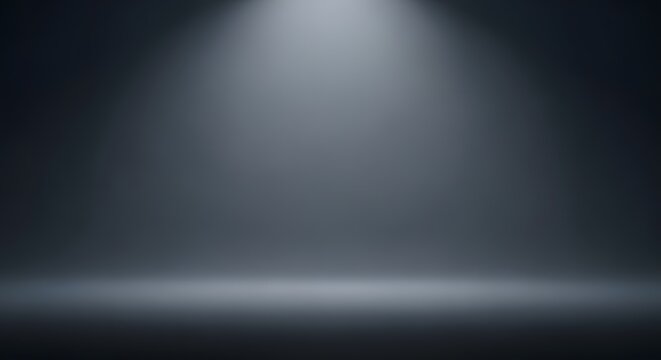 Spotlight illuminates an empty dark studio background creating a clean stage for product placement.