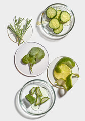 Obraz premium Flat lay of natural cosmetic ingredients in petri dishes on white background