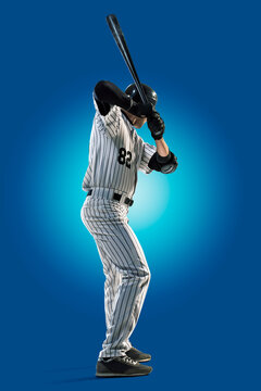 Baseball. Professional baseball player isolated on blue background. Baseball player in action