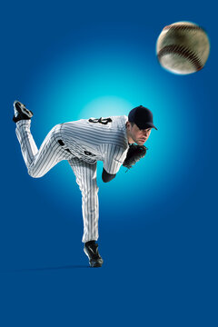 Baseball. Professional baseball player isolated on blue background. Baseball player in action