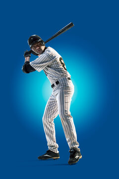 Baseball. Professional baseball player isolated on blue background. Baseball player in action