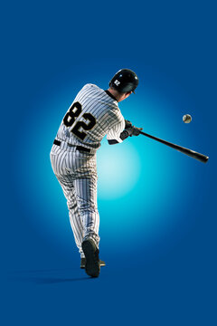 Baseball. Professional baseball player isolated on blue background. Baseball player in action