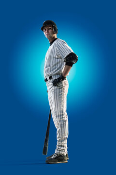 Baseball. Professional baseball player isolated on blue background. Baseball player in action