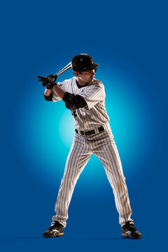 Baseball. Professional baseball player isolated on blue background. Baseball player in action