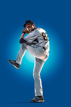Baseball. Professional baseball player isolated on blue background. Baseball player in action