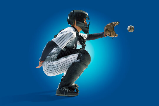 Baseball. Professional baseball player isolated on blue background. Baseball player in action