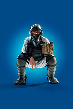 Baseball. Professional baseball player isolated on blue background. Baseball player in action