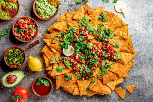 Nachos. Totopos with sauces. Mexican food concept. Yellow corn totopos chips with different sauces 