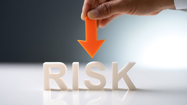 Business Hand Hold Arrow Decrease Risk Word Concept with White Letters on a Clean Surface and Gradient Background